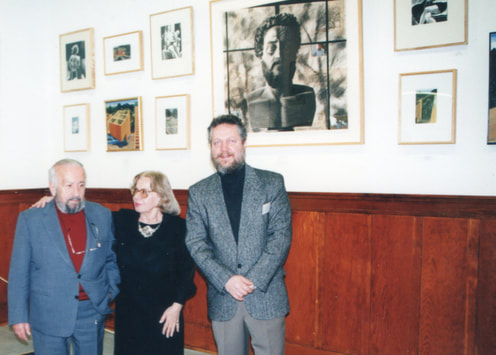 Frantzis and Catherine Frantzeskakis with painter Angelos Sakkis in front of some of his work at Stoa Gallery.